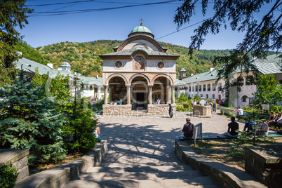 Cozia monastery church with visiting tourists