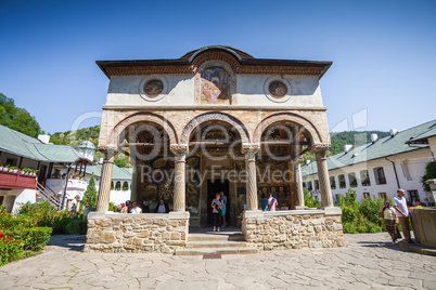 Cozia monastery church with visiting tourists