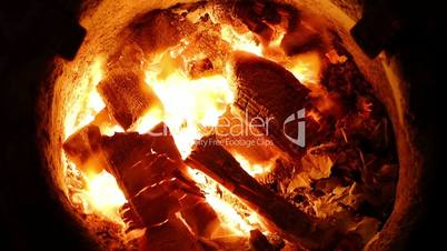 Burning charcoal in an outdoor clay stove