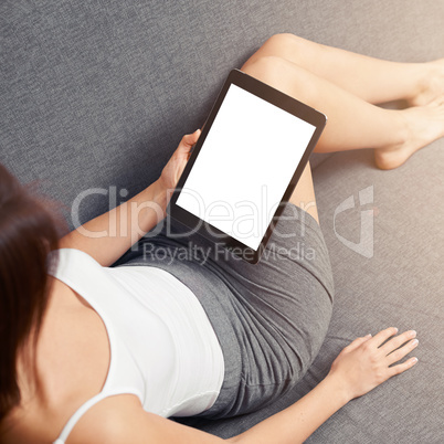 Woman takes a rest with tablet, on sofa