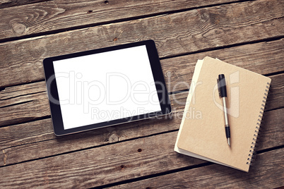 Tablet and notepad on desktop