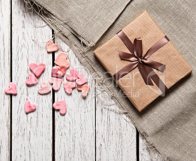 Gift box with heap of small hearts