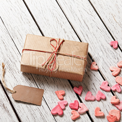Gift box with blank gift tag and heap of hearts