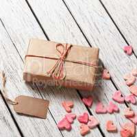 Gift box with blank gift tag and heap of hearts