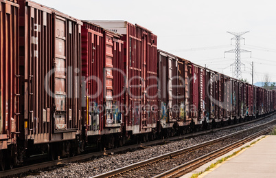 Red freight train box cars in perspective