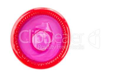 red condom on white background from topview