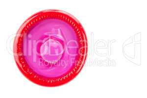 red condom on white background from topview