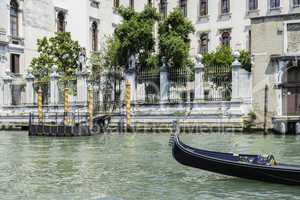 Ancient buildings and boats in the channel in Venice