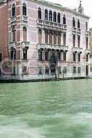 Ancient buildings and boats in the channel in Venice