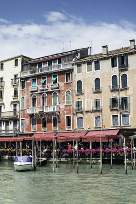 Ancient buildings and boats in the channel in Venice