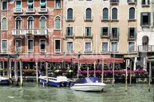 Ancient buildings and boats in the channel in Venice