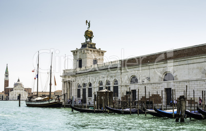 Ancient buildings and boats in the channel in Venice