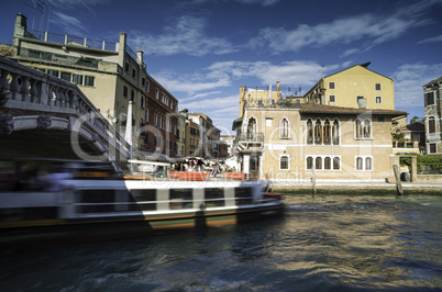 Ancient buildings and boats in the channel in Venice