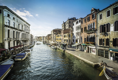 Ancient buildings and boats in the channel in Venice