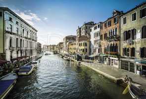 Ancient buildings and boats in the channel in Venice