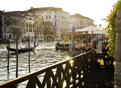 Ancient buildings and boats in the channel in Venice.