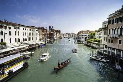 Ancient buildings and boats in the channel in Venice