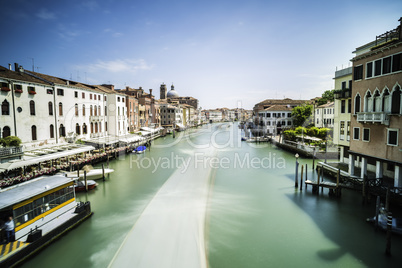 Ancient buildings and boats in the channel in Venice