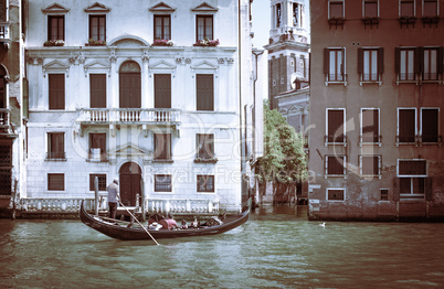 Ancient buildings in Venice. Boats moored in the channel. Gondol