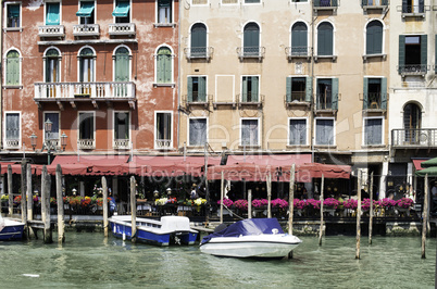 Ancient buildings and boats in the channel in Venice