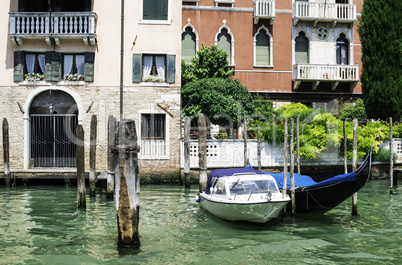 Ancient buildings and boats in the channel in Venice