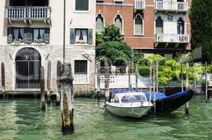 Ancient buildings and boats in the channel in Venice