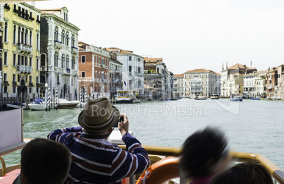 Ancient buildings and boats in the channel in Venice