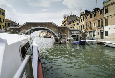 Ancient buildings and boats in the channel in Venice