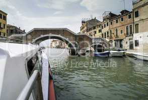 Ancient buildings and boats in the channel in Venice