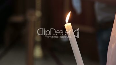 Woman holding candle in church
