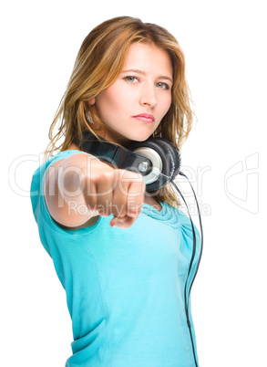 Young woman is showing a fist on white.