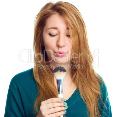 Girl is applying makeup  using brush