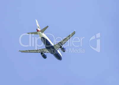 Flying plane on blue sky background
