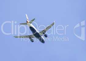 Flying plane on blue sky background