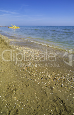 Yellow lifeboat on the beach.