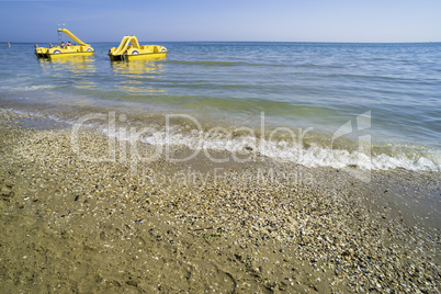 Yellow lifeboat on the beach.