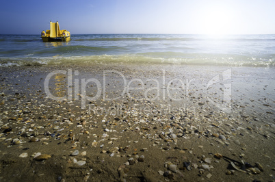 Yellow lifeboat on the beach.