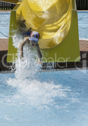 Children slide down a water slide