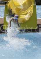 Children slide down a water slide