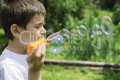 Child makes bubbles