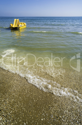 Yellow lifeboat on the beach.