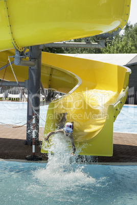 Children slide down a water slide