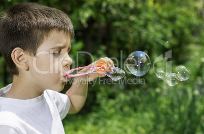 Child makes bubbles