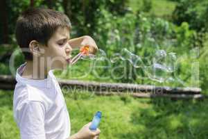 Child makes bubbles