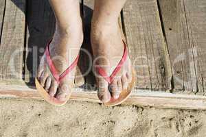 Women foots on the beach