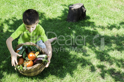 Child and basket with vegetables