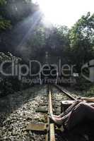 Woman and vintage suitcase on railway road