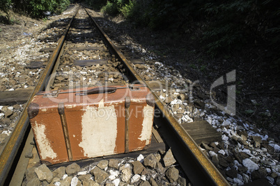 Vintage suitcase on railway road