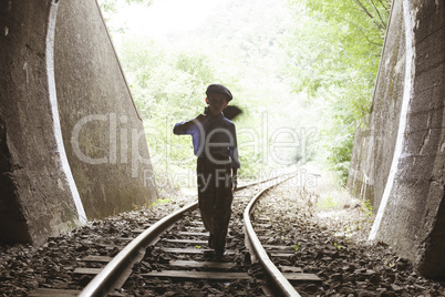 Child walking on railway road