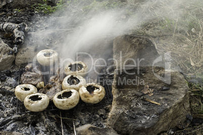 Mushrooms grilled on a coals in nature